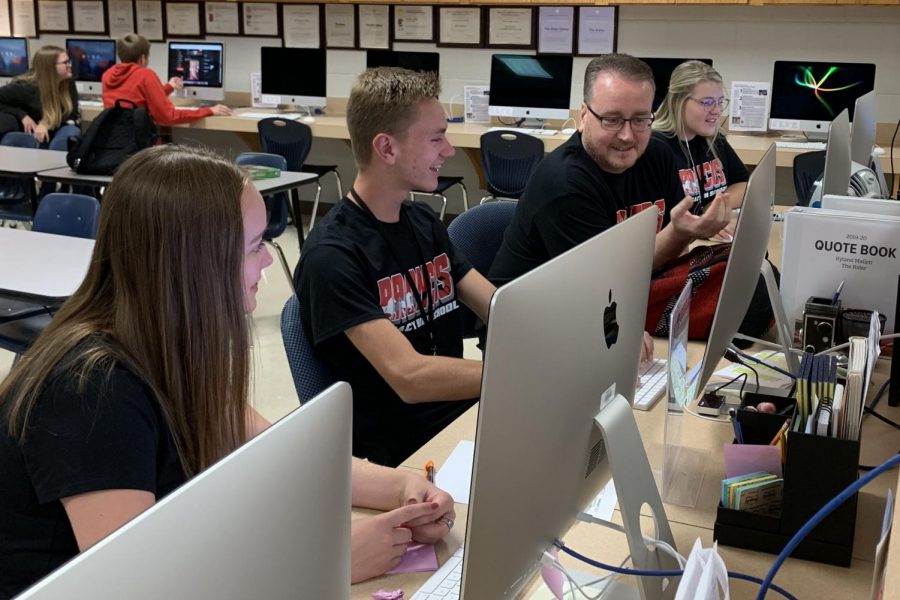 Mr. Leland Mallett assists editors Brinley Koenig, 12, and Ryland Mallett, 12, during the Newspaper class. Mallett will recieve the Journalism Educators Association’s Medal of Merit this fall. 