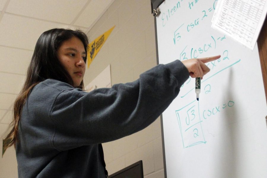 Eileen Castrellon, 12, studies math on a whiteboard in AVID.