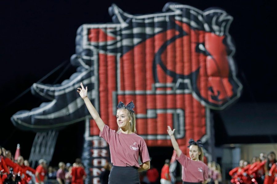 Claire Bagley, 11, holds up the L sign as the band plays the school song. (Seth Miller photo)