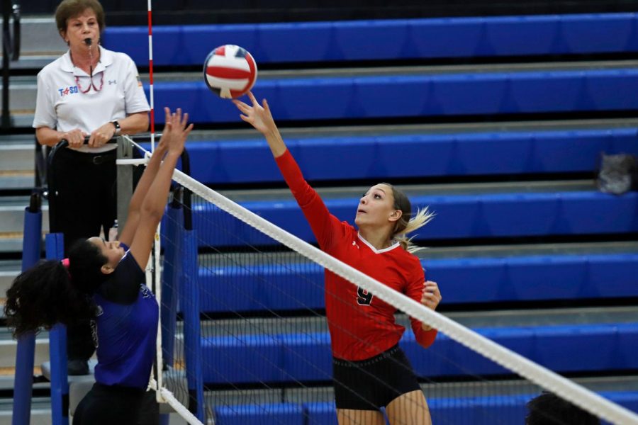  Alexandria Gentry, 11, tips the ball over the net against Everman. (Seth Miller photo)