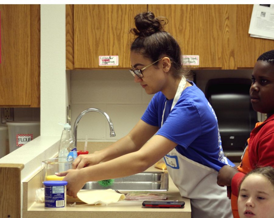 Emily Ledesma, 11, prepares food at the culinary camp in the summer. 