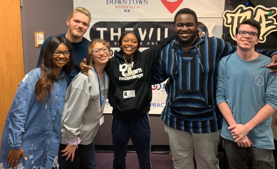 Singer Kaash Paige (center) poses with her old classmates. Paige visited the Practicum Digital Audio class at Ben  Barber so the students could interview her.  