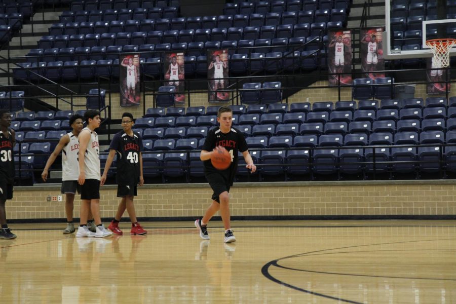 Robert Bradley, 9, dribbles the basketball during a game. Bradley plays basketball despite missing a rib. 