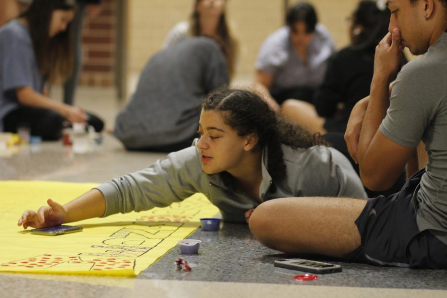 Christine Holley, 12, decorates posters for homecoming with other members of student council. StuCo will host the TASC conference in 2021. 