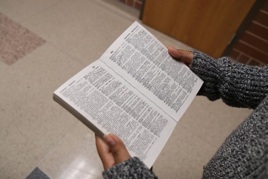 During 6th period, Rosalinda Sanchez, 11, reads an English dictionary in the hallway at Mansfield Legacy High School on Jan. 22. The English Language Learners (ELL) learn English through core classes.