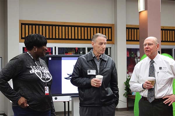 Dr. Butler (left) speaks with school board members at the breakfast hosted by StuCo. 