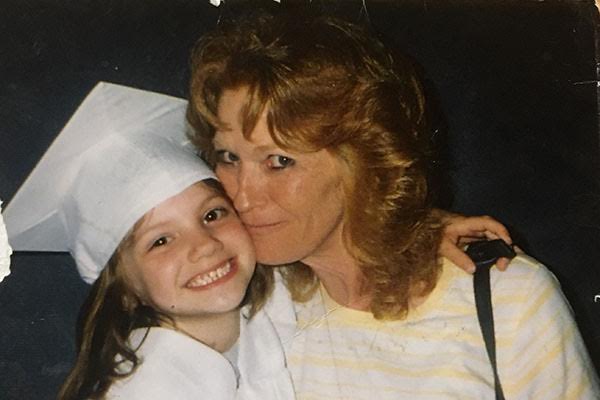 Amber Trammell, 11, poses with her grandmother during a school ceremony. 