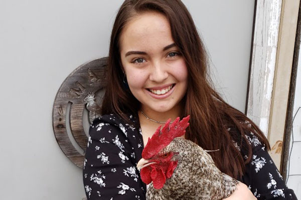 Madison Asato, 12, poses with her chicken. 