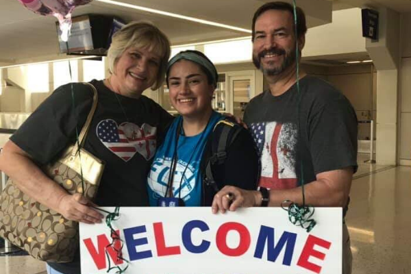 Nanuka Dudashvili, 12, poses for a picture with her host family at the airport. 