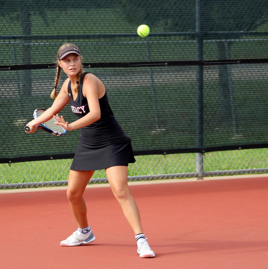 Tatum Sikes,11, hits a forehand in the varsity tennis match against Duncanville on Sept. 11.