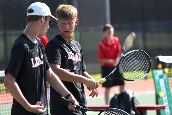 Noah Batson, 12, talks with Jantzen Redwine, 9, during a doubles match against Burleson. The team advanced to bi-district playoffs against Fort Worth Arlington Heights on Oct. 26. 
