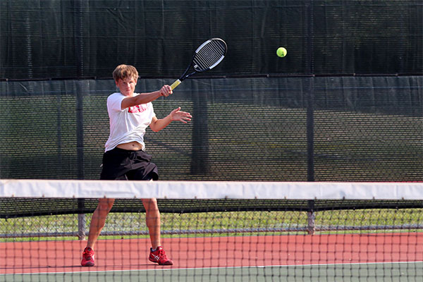 Freshman Jantzen Redwine hits the ball in the match against Burleson Centennial.