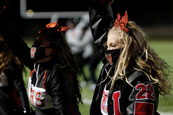 At the Varsity Football game, junior Ashlyn Liukonen cheers on the sideline after returning from the team's two week quarantine.