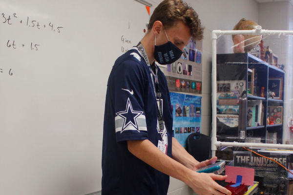 Junior Andrew Bobe participates in a lab in his  physics class. 