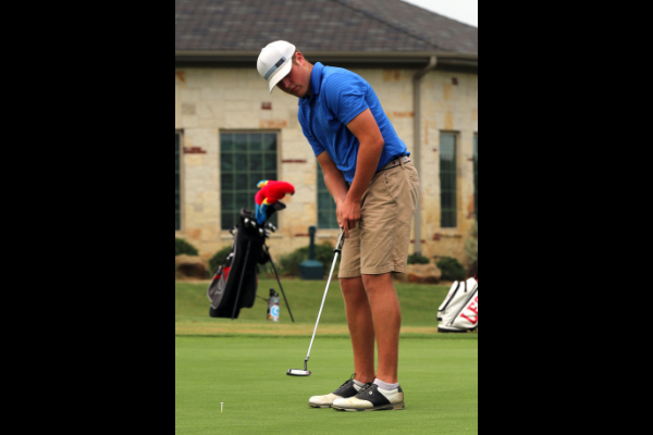 Ty Maxwell, 12, practices his putting on the green.