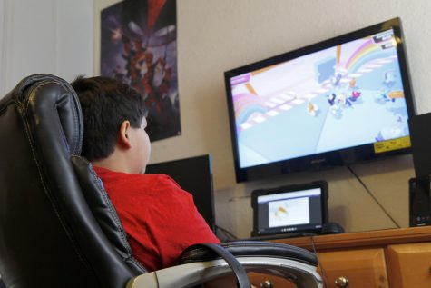 Sophomore Andy Gonzales completes his schoolwork virtually while simultaneously playing video games while all students were still virtual. Students returned to school in-person on Sep. 8. 