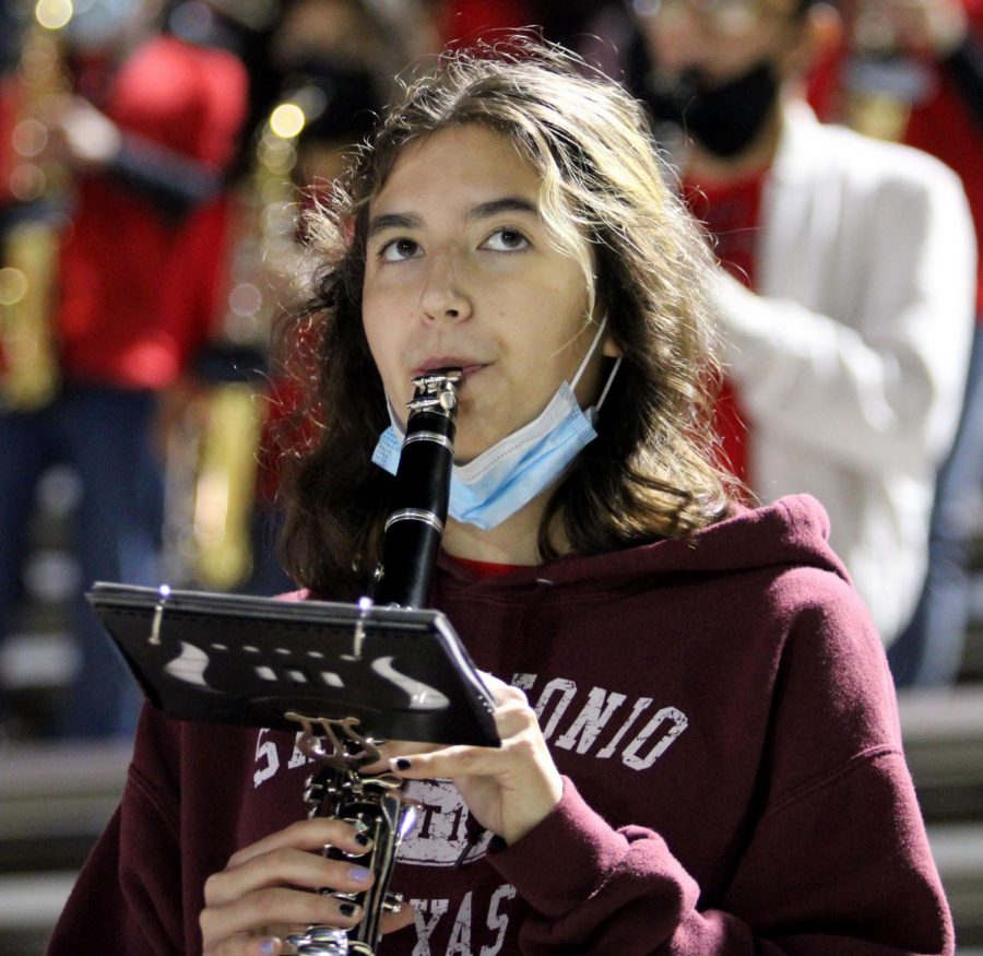 Azja Farabee, 10, plays clarinet in the stands with her fellow band mates. (Hayley Parsons Photo)
