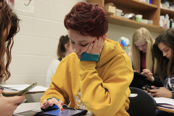 Kaitlyn Skelton, 10, works on her IPad in Mr. Szosteks 2nd period class. Skelton has a severe peanut allergy.