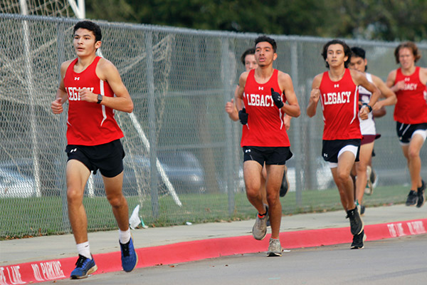 At the cross country meet against other Mansfield teams, freshman Toby Eaton runs ahead of the group towards the finish line. 