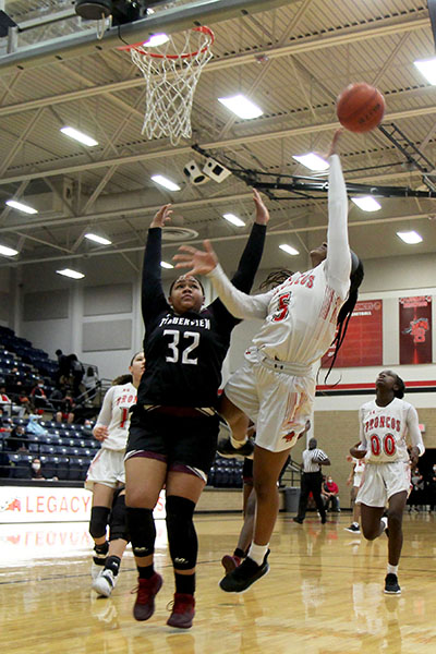 With her eyes on the ball Savannah Catalon, 10, goes for a lay-up at the varsity girls game against Timberview on Jan. 22. The Broncos won, 46-21. (Landri Hargrove Photo)
