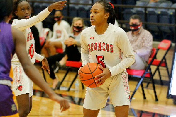 Savannah Catalon, 10, looks for an open teammate at the varsity girls basketball game vs Everman. The team will play in round 3 of playoffs on Feb. 24. 