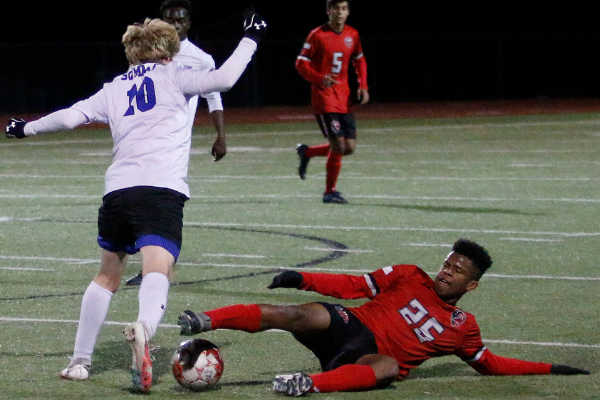 Joshua Omorodion, 11, slides to reclaim the ball versus Summit.