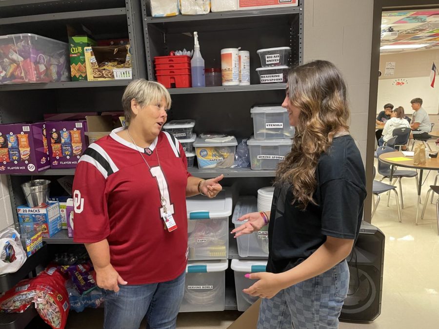 Stuco Adviser, Kenna Canvar discusses pantry items with Sudent Body President, Catherine Walworth 