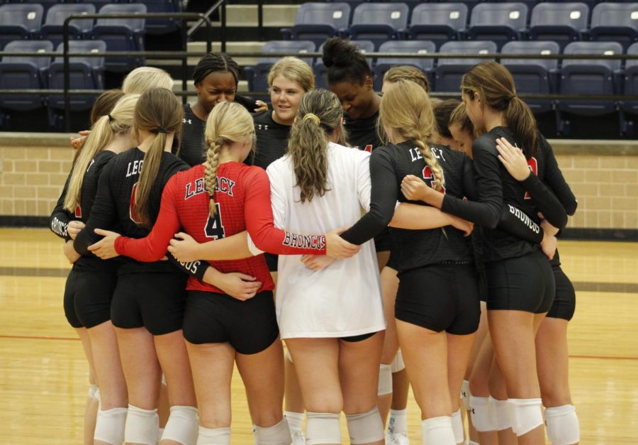 During the volleyball game against Burleson Centennial, the varsity team huddles together. 