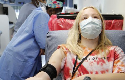 Landri Hargrove, 12, gives blood on the Carter Blood Care Blood Bus.