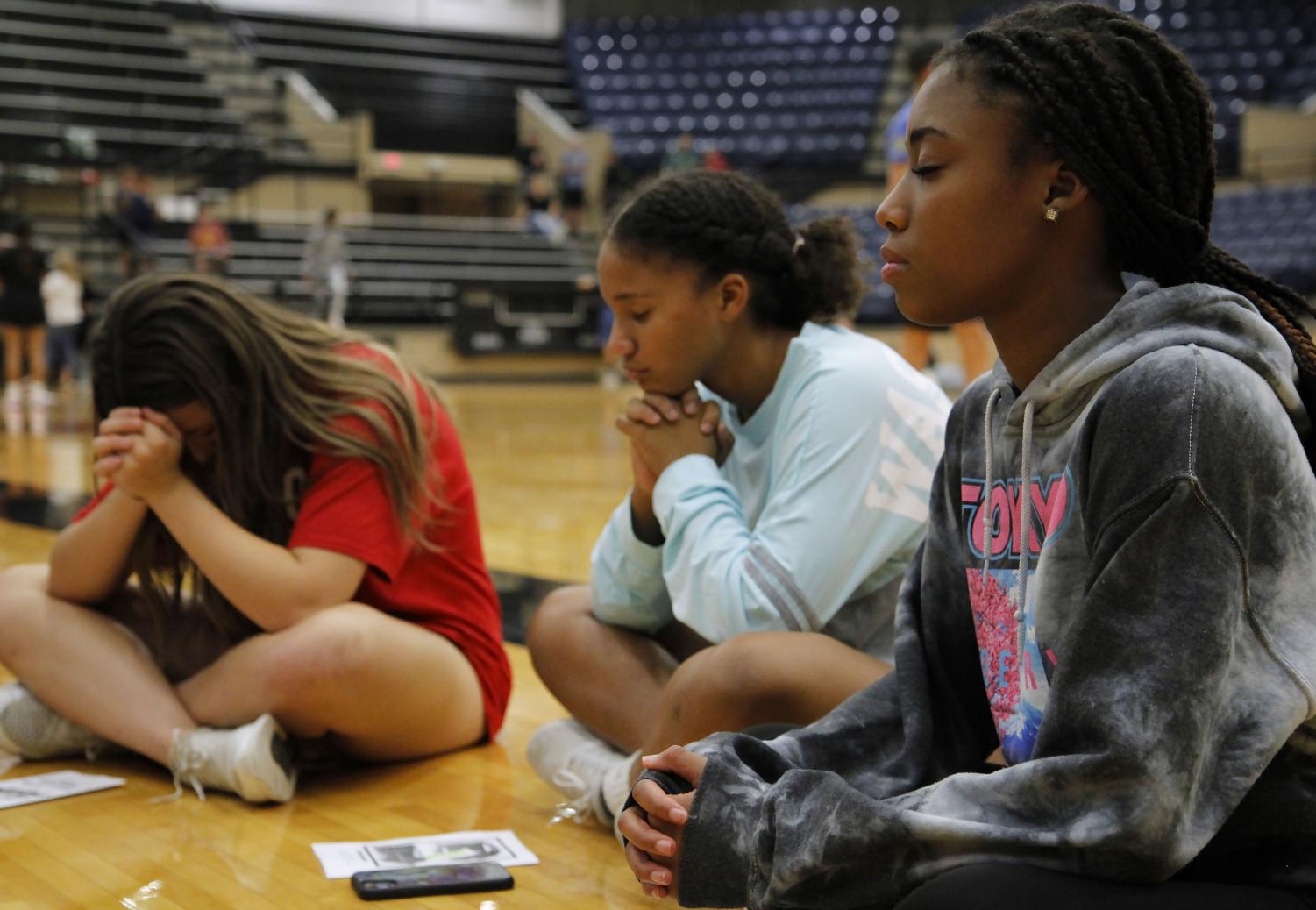 Students pray at the FCA at the kickoff event on Oct. 18. FCA hosts huddles monthly.