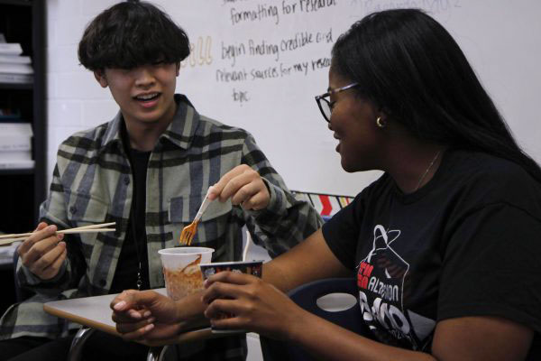 Lisa Orie, 12, and Ryan Nguyen, 10, eat spicy ramen. The Asian Student Union hosted a ramen eating contest.