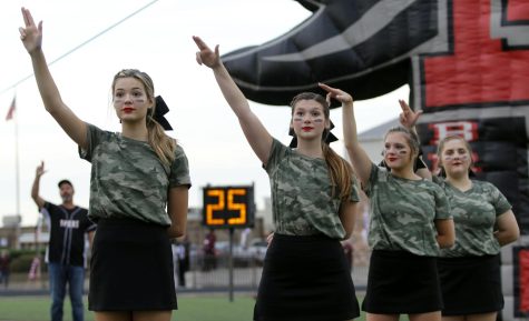 Members of the varsity cheer team hold the Legacy L before the game against Red Oak on  Sept. 24.