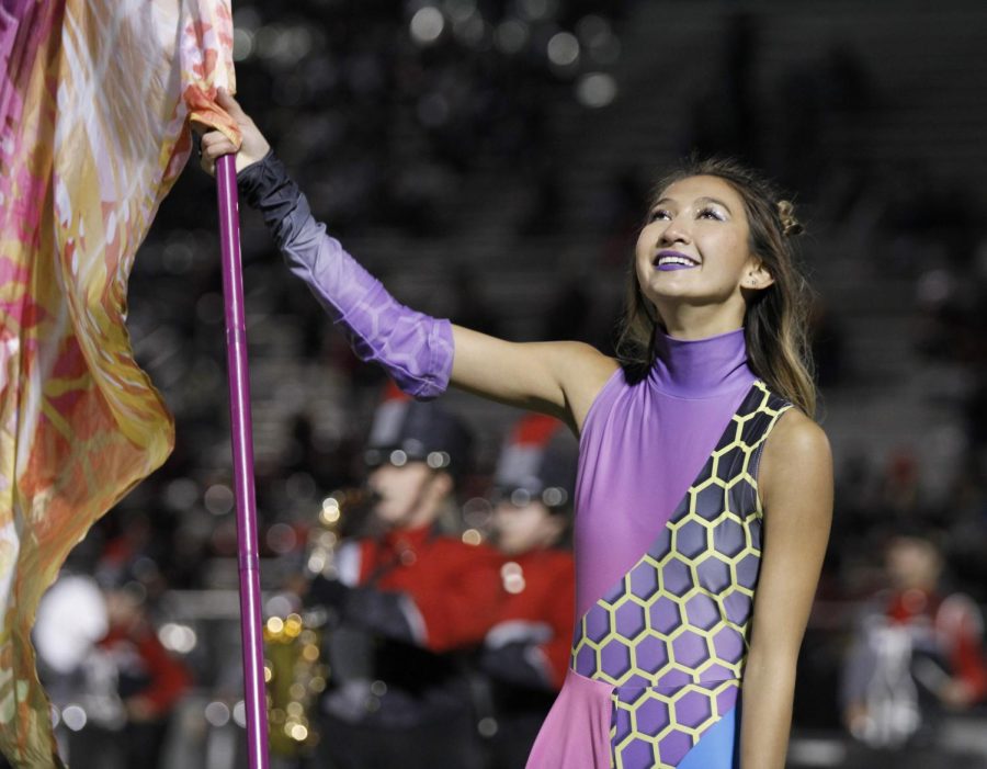 Color Guard and band perform on the field for Senior Night.