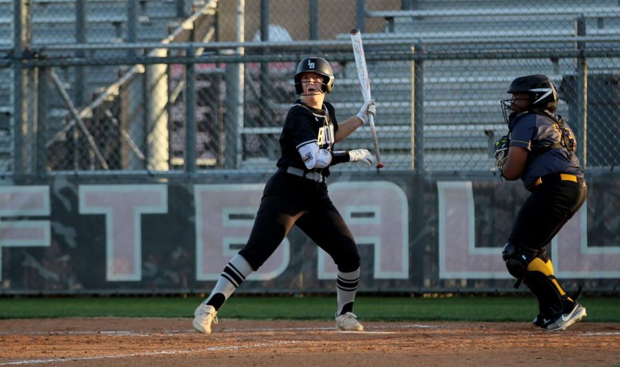 Junior Lucy Ballard prepares to hit in the game against Everman High School on March 25. Varsity softball advanced to post season playoffs with a 13-1 district record.