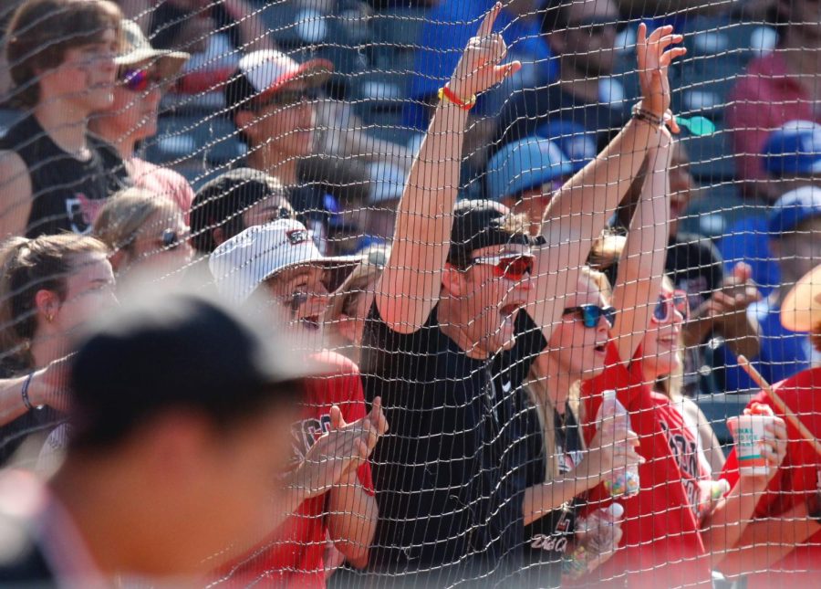 Fans celebrate two runs scored by the Broncos. Fans traveled several hours to support the Broncos in a district and school-first trip to the state playoffs for baseball.