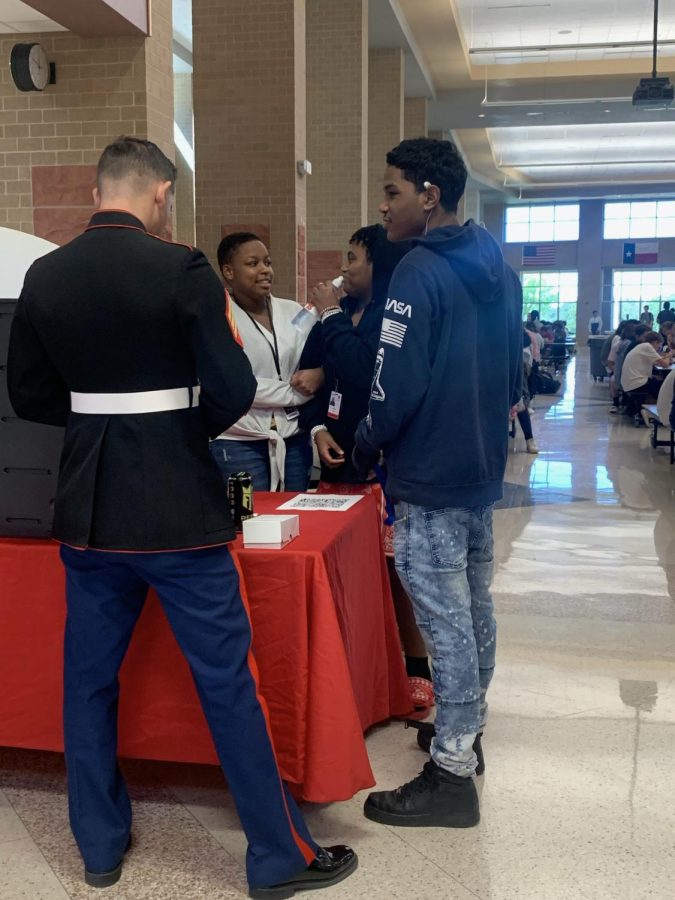 Trevon, 11, talks to Marines during lunch about joining after high school and the benefits. 