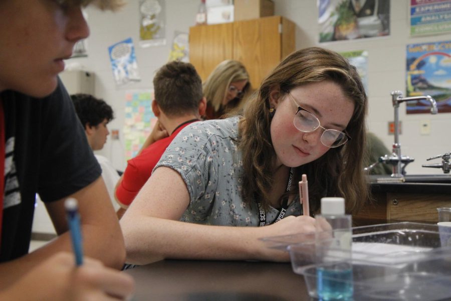 Junior Mariah Hanlon records results of a lab in AP Biology. Studies show students continually experience the pressure of academics when considering long-term success. 