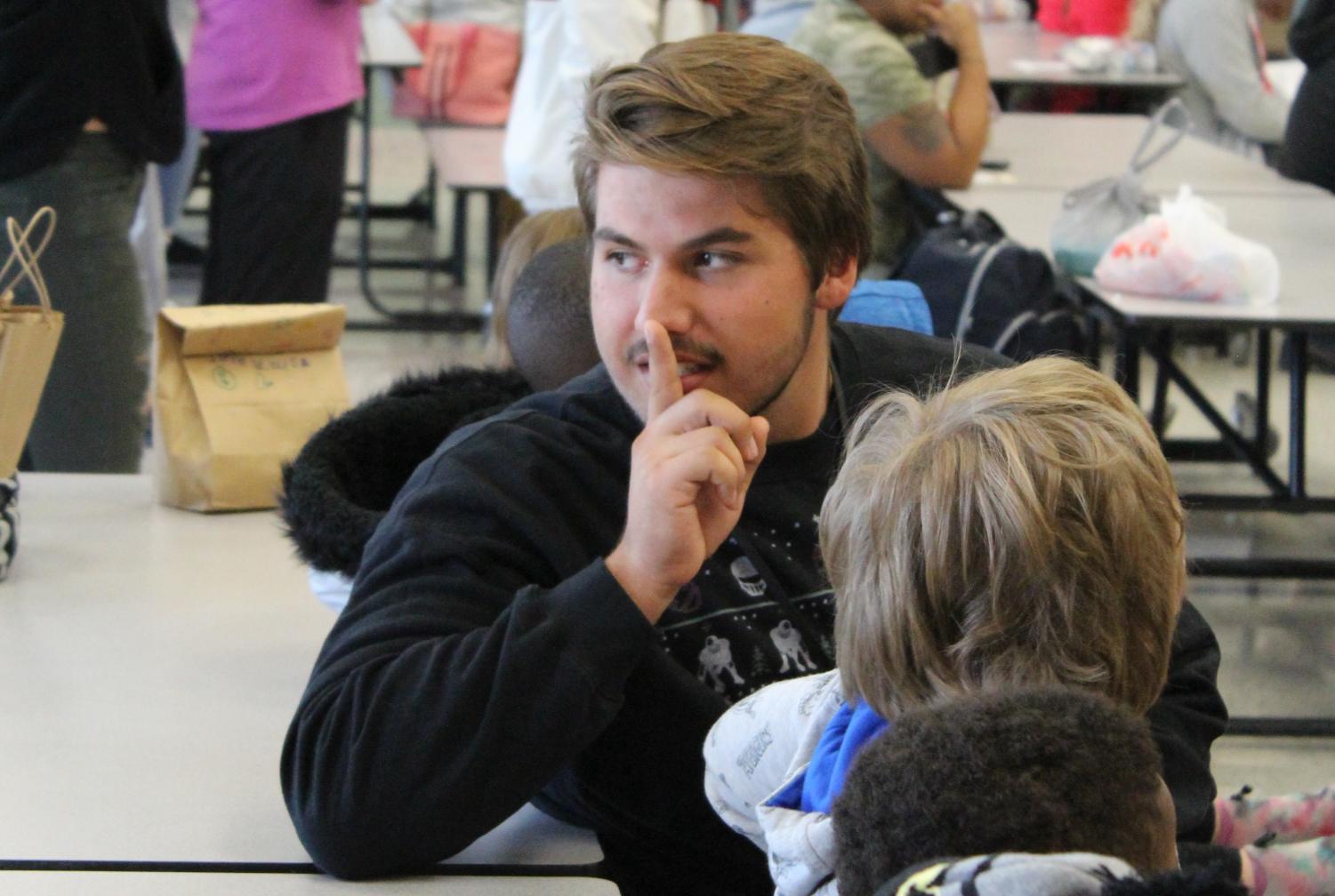 Junior Jonah Pedroza reminds his mentees to stay quiet in the cafeteria on Nov. 18 at Annette Perry Elementary.
