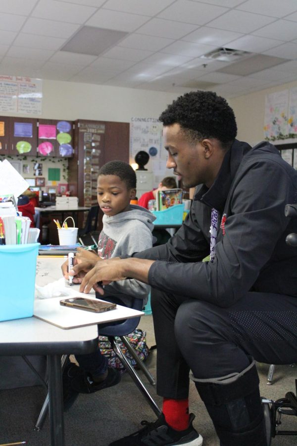 Senior Isaiah Manning works with his mentee at Mary Jo Sheppard Elementary on Nov. 18.