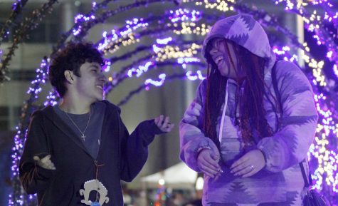 Juniors Arnoldo Chavez and Keslynn Smith walk under the Tunnel of Lights at the Toys for Tots event on Nov. 30. The Center hosted the event to raise toys and money for local children.