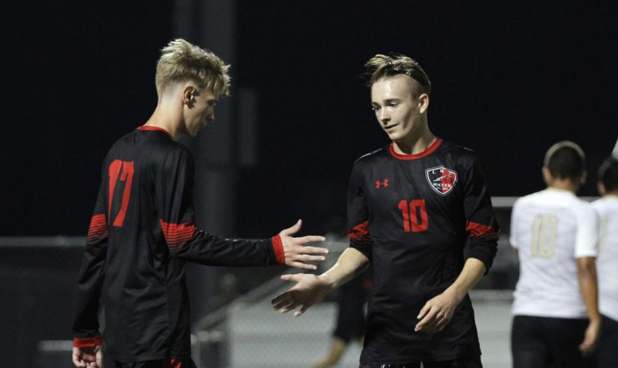 Cooper Axe, 11, does a handshake with a teammate before the Dec. 10 JV soccer game against Cleburne. [File Photo]