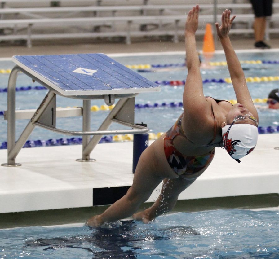 During a practice at the MISD Natatorium, Robi Hablo, 12, works on her back stroke dive.