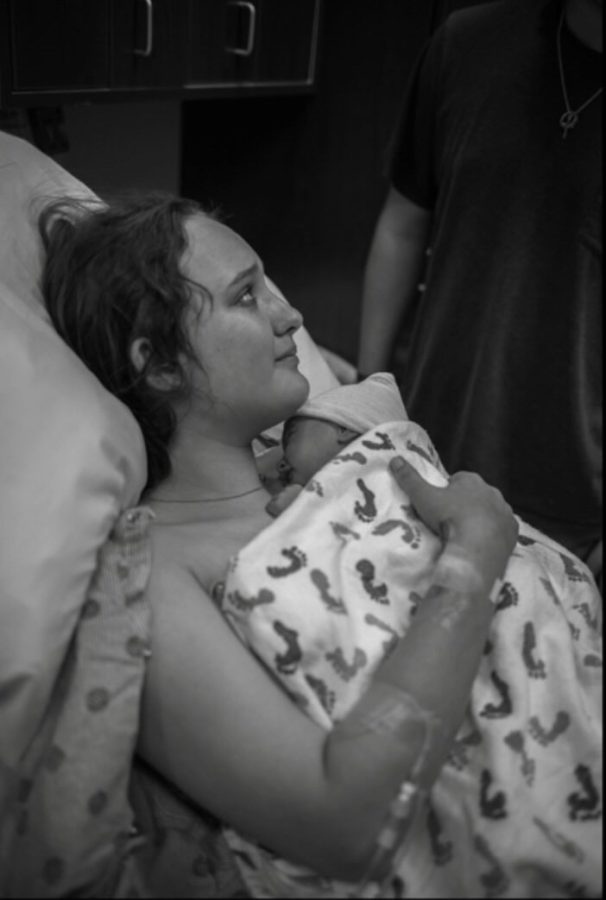 Allyson Williams, 11, holds her baby for the first time. 