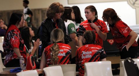 The bowling team talks in between turns at the match on Dec. 3, 2022.