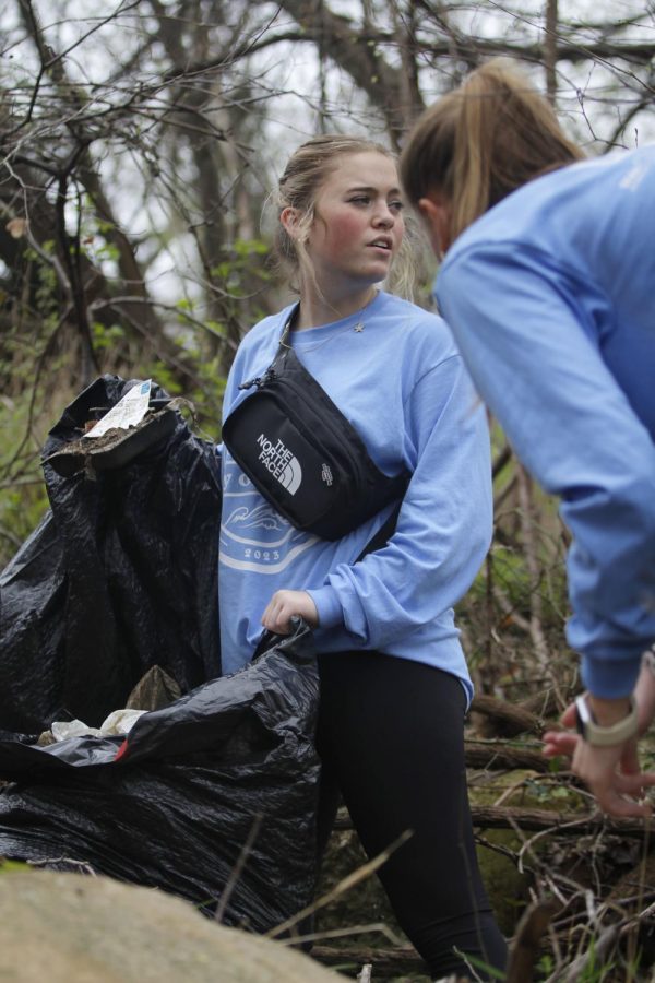 Annelise Vinson, 11, picks up trash at Town Crossing Park in Mansfield. Over 400 volunteers participated in Day of Service.