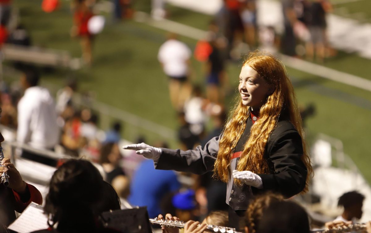 Junior Abigail Warren directs the band during the homecoming football Oct. 6. Warren placed 29th in the state for flute.