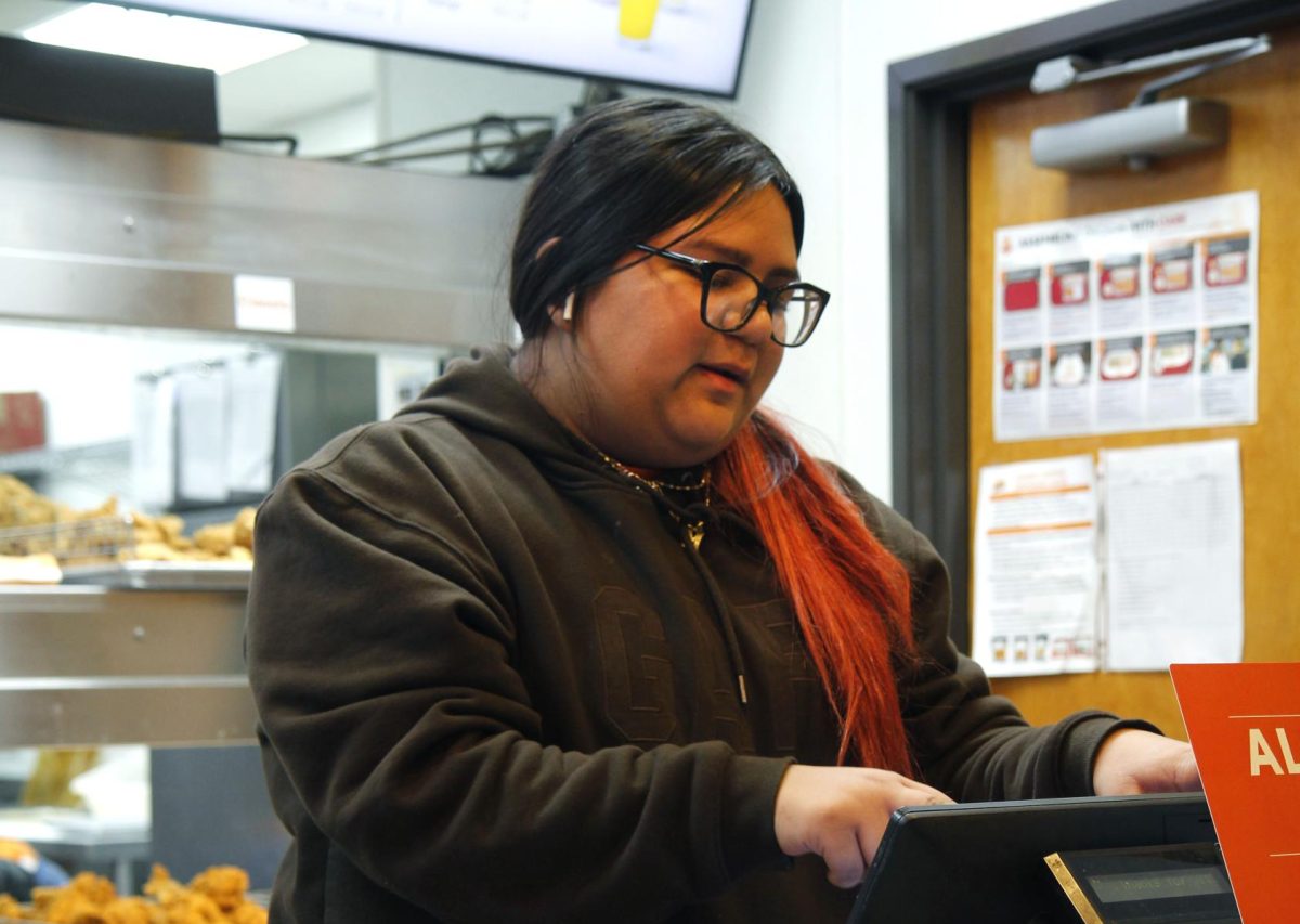Maria Limas, 11, inputs an order for a customer at Popeyes on Dec. 4. 