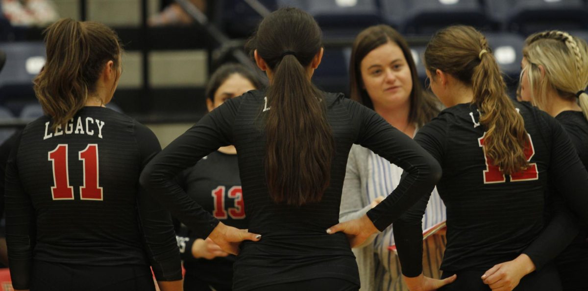 Coach Rachel Ryan talks with the JV volleyball team during the Sept. 20 game against Waxahachie.