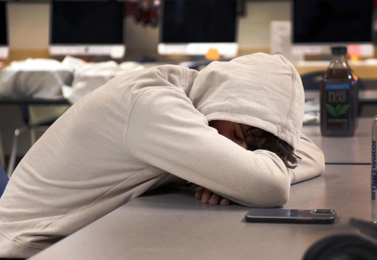A student sleeps during his advisory class. Under the new change, students will stay in their seconds and sixth periods, but can travel to other teachers classrooms for tutoring or extra help.