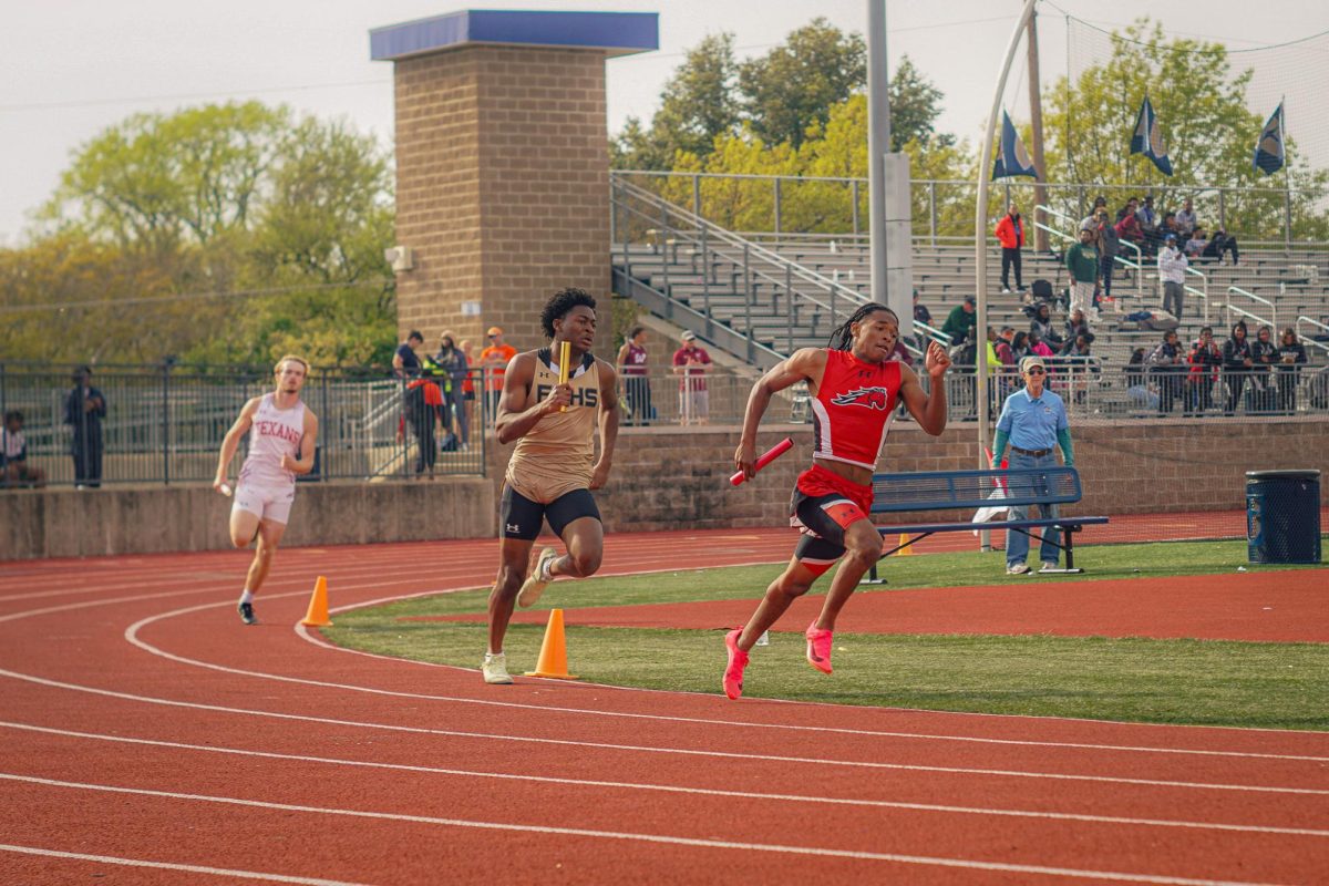 Sophomore+DAndre+Thomas+runs+the+4x4+relay+at+Jesuit+High+School+on+March+23.